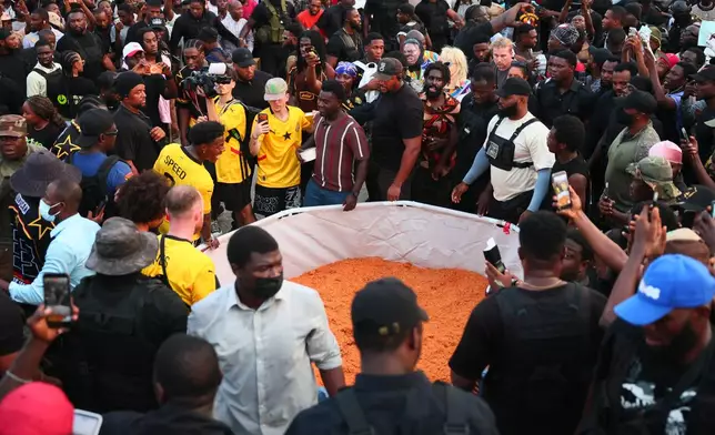 American YouTuber and online streamer Darren Jason Watkins Jr., better known as IShowSpeed, is served Ghana jollof rice at Independence Square in Accra, Ghana, during his Africa tour, Monday, Jan. 26, 2026. (AP Photo/Tsraha Yaw)