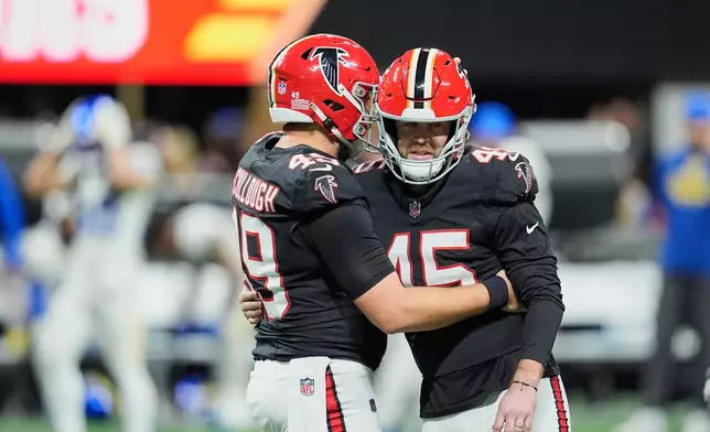 Atlanta Falcons place kicker Zane Gonzalez (45) celebrates his go-ahead field goal with long snapper Liam McCullough (49) in the second half of an NFL football game against the Los Angeles Rams, Monday, Dec. 29, 2025, in Atlanta. (AP Photo/Mike Stewart)