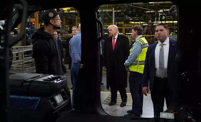 President Donald Trump listens during a tour of the Ford River Rogue complex, Tuesday, Jan. 13, 2026, in Dearborn, Mich. (AP Photo/Evan Vucci)