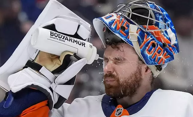 New York Islanders goalie Ilya Sorokin squirts water on his face during a stoppage in play during the third period of an NHL hockey game against the Vancouver Canucks, in Vancouver, B.C., Monday, Jan. 19, 2026. (Darryl Dyck/The Canadian Press via AP)