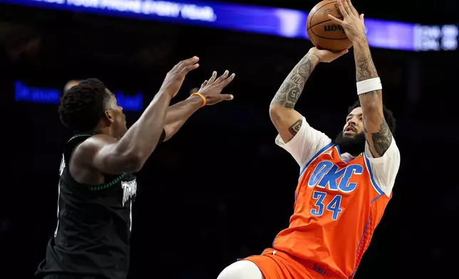 Oklahoma City Thunder guard Kenrich Williams, right, shoots over Minnesota Timberwolves guard Anthony Edwards (5) during the first half of an NBA basketball game, Thursday, Jan. 29, 2026, in Minneapolis. (AP Photo/Matt Krohn)