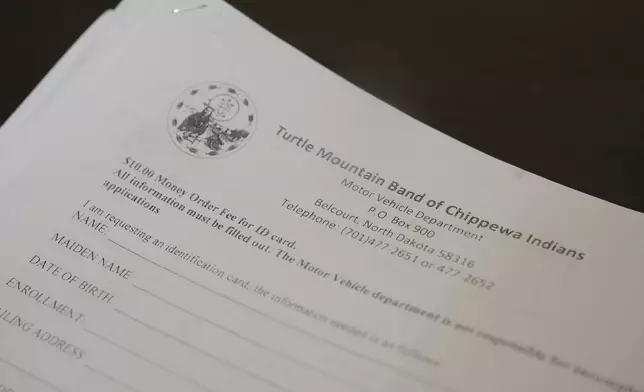 Paperwork to apply for a tribal identification card is displayed Friday, Jan. 23, 2026, in Minneapolis. (AP Photo/Abbie Parr)