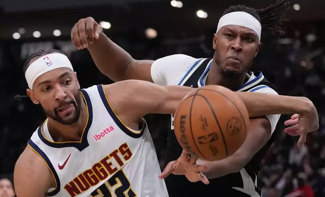 Milwaukee Bucks' Myles Turner and Denver Nuggets' Zeke Nnaji go after a loose ball during the first half of an NBA basketball game Friday, Jan. 23, 2026, in Milwaukee. (AP Photo/Morry Gash)