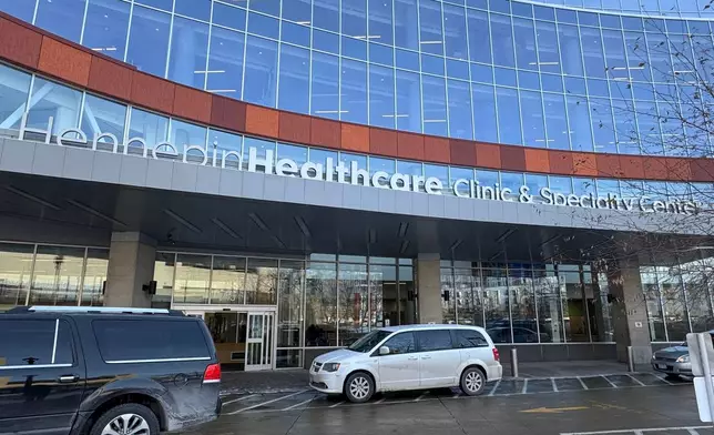 Cars are parked outside Hennepin County Medical Center on Tuesday, Jan. 20, 2026, in Minneapolis. (AP Photo/Sarah Raza)