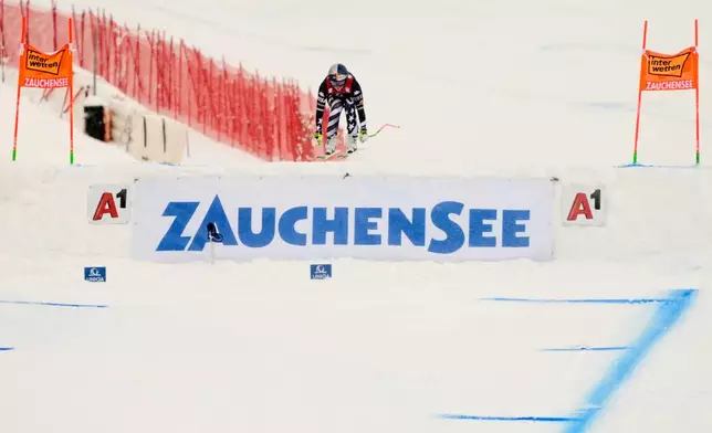 United States' Lindsey Vonn is airborne as she speeds down the course to win an alpine ski, women's World Cup downhill, in Zauchensee, Austria, Saturday, Jan. 10, 2026. (AP Photo/Giovanni Auletta)