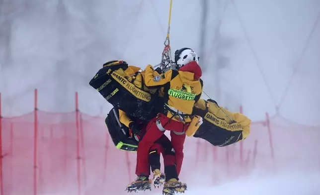 Austria's Magdalena Egger is lifted on a helicopter after crashing during an alpine ski, women's World Cup downhill, in Zauchensee, Austria, Saturday, Jan. 10, 2026. (AP Photo/Marco Trovati)