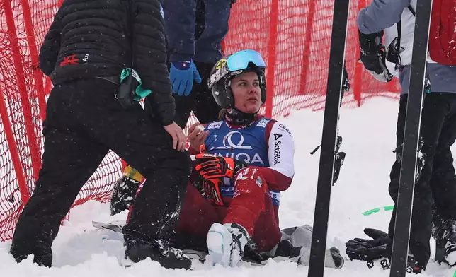 Austria's Magdalena Egger gets medical assistance after crashing during an alpine ski, women's World Cup downhill, in Zauchensee, Austria, Saturday, Jan. 10, 2026. (AP Photo/Marco Trovati)