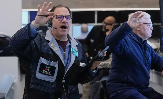 Anthony Spina, left, works with fellow options traders on the floor of the New York Stock Exchange, Wednesday, Jan. 28, 2026. (AP Photo/Richard Drew)