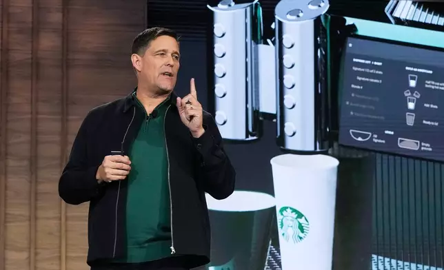 Executive Vice President and Chief Operating Officer Mike Grams speaks during the Starbucks Investor Day event, with an image of the company's Mastrena 3 espresso machine, in New York, Thursday, Jan. 29, 2026. (AP Photo/Richard Drew)