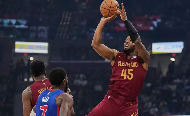 Cleveland Cavaliers guard Donovan Mitchell (45) shoots over Detroit Pistons forward Paul Reed (7) in the first half of an NBA basketball game Sunday, Jan. 4, 2026, in Cleveland. (AP Photo/Sue Ogrocki)