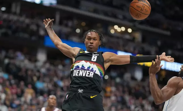 Denver Nuggets guard Peyton Watson (8) reacts after dunking over Los Angeles Clippers forward Kawhi Leonard in the first half of an NBA basketball game Friday, Jan. 30, 2026, in Denver. (AP Photo/David Zalubowski)