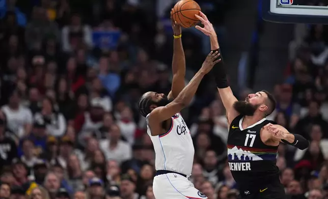 Denver Nuggets center Jonas Valančiūnas, right, blocks a shot by Los Angeles Clippers guard James Harden, left, in the first half of an NBA basketball game Friday, Jan. 30, 2026, in Denver. (AP Photo/David Zalubowski)
