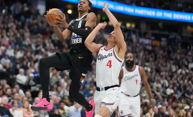 Denver Nuggets guard Peyton Watson, left, drives to the basket as Los Angeles Clippers guard Kobe Sanders (4) defends in the first half of an NBA basketball game Friday, Jan. 30, 2026, in Denver. (AP Photo/David Zalubowski)