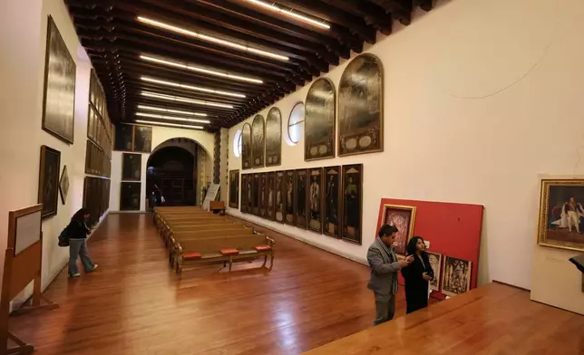 People look at the restored art gallery at La Profesa church in Mexico City, Tuesday, Jan. 27, 2026. (AP Photo/Ginnette Riquelme)