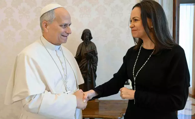 This image released by Vatican Media shows Pope Leo XIV meeting with Nobel Peace Prize laureate María Corina Machado of Venezuela, right, inside his private library at the Vatican, Monday, Jan. 12, 2026. (Vatican Media via AP, HO)