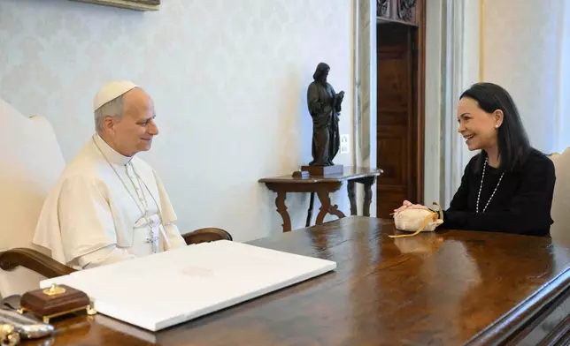 This image released by Vatican Media shows Pope Leo XIV meeting with Nobel Peace Prize laureate María Corina Machado of Venezuela, right, inside his private library at the Vatican, Monday, Jan. 12, 2026. (Vatican Media via AP, HO)