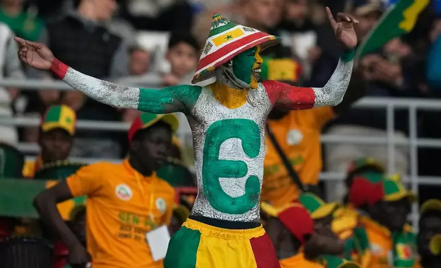 A senegalese fan cheers during the Africa Cup of Nations group D soccer match between Benin and Senegal in Tangier, Morocco, Tuesday, Dec. 30, 2025. (AP Photo/Themba Hadebe)