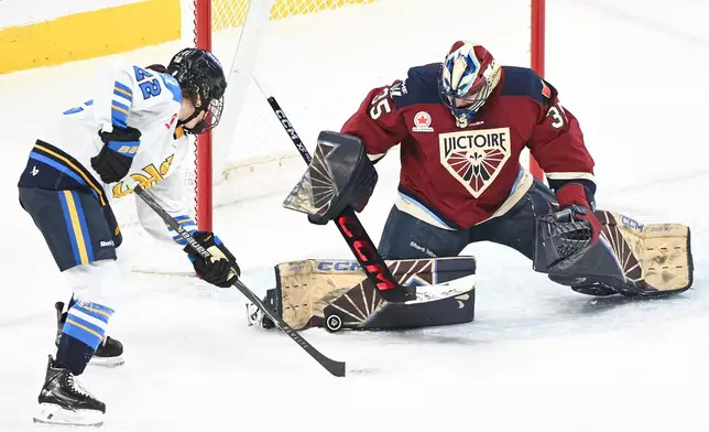 Montreal Victoire goaltender Ann-Renee Desbiens makes a save against Toronto Sceptres' Maggie Connors (22) during the second period of an PWHL hockey game in Laval, Quebec, Wednesday, Jan. 28, 2026. (Graham Hughes/The Canadian Press via AP)