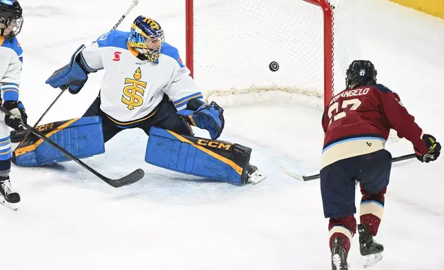 Montreal Victoire's Shiann Darkangelo (27) scores against Toronto Sceptres' goaltender Raygan Kirk during the second period of an PWHL hockey game in Laval, Quebec, Wednesday, Jan. 28, 2026. (Graham Hughes/The Canadian Press via AP)