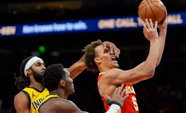 Atlanta Hawks guard Dyson Daniels (5) shoots against Indiana Pacers guard Bennedict Mathurin (00) during the second half of an NBA basketball game, Monday, Jan. 26, 2026, in Atlanta. (AP Photo/Mike Stewart)