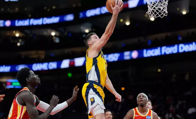 Indiana Pacers guard T.J. McConnell (9) shoots against the Atlanta Hawks during the first half of an NBA basketball game, Monday, Jan. 26, 2026, in Atlanta. (AP Photo/Mike Stewart)