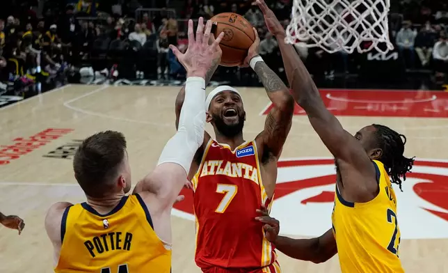 Atlanta Hawks guard Nickeil Alexander-Walker (7) shoots against Indiana Pacers center Micah Potter (11) during the second half of an NBA basketball game, Monday, Jan. 26, 2026, in Atlanta. (AP Photo/Mike Stewart)