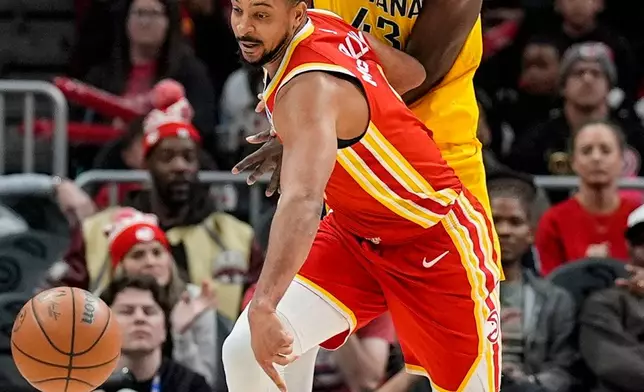 Atlanta Hawks guard CJ McCollum (3) and Indiana Pacers forward Pascal Siakam (43) vie for a loose ball during the second half of an NBA basketball game, Monday, Jan. 26, 2026, in Atlanta. (AP Photo/Mike Stewart)