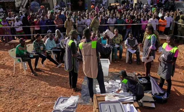 Election officials count ballots after the polls closed for the presidential election at a polling station in Kampala, Uganda, Thursday, Jan. 15, 2026. (AP Photo/Brian Inganga)