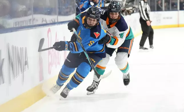 Toronto Sceptres' Savannah Harmon, left, competes for the puck with New York Sirens' Elle Hartje during first period PWHL hockey action, in Toronto, on Tuesday Jan. 6, 2026. (Chris Young/The Canadian Press via AP)