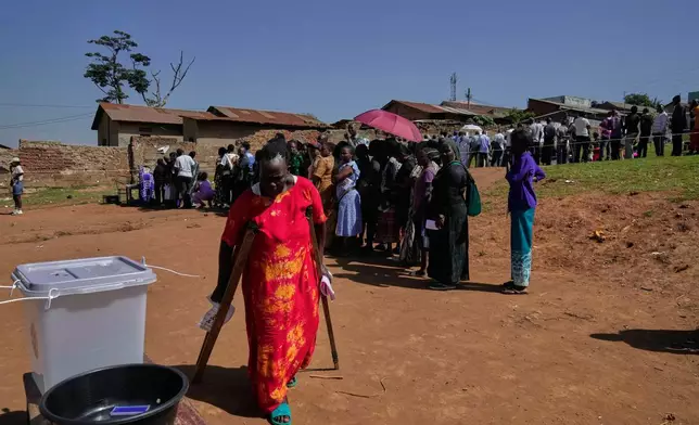 Voters line up to cast their ballots at a polling station, during the presidential election, in the capital, Kampala, Uganda, Thursday, Jan. 15, 2026. (AP Photo/Brian Inganga)