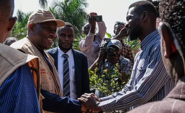 Uganda opposition presidential candidate Robert Kyagulanyi Ssentamu, known as Bobi Wine, right, greets election observers, including former Nigerian President Goodluck Jonathan, at his home in Magere village on the outskirts of Kampala, Uganda, Wednesday, Jan. 14, 2026. (AP Photo/Hajarah Nalwadda)