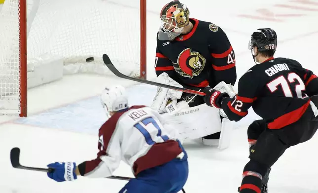 Colorado Avalanche's Parker Kelly (17) scores on Ottawa Senators' goaltender James Reimer while Thomas Chabot (72) looks on during the second period of an NHL hockey game in Ottawa, Ontario, on Wednesday, Jan. 28, 2026. (Patrick Doyle/The Canadian Press via AP)