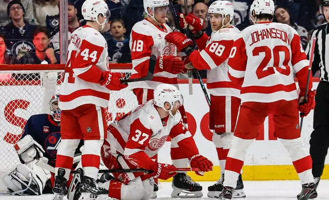 Detroit Red Wings' J.T. Compher (37) celebrates after he scored against the Winnipeg Jets during second-period NHL hockey game action in Winnipeg, Manitoba, Saturday, Jan. 24, 2026. (John Woods/The Canadian Press via AP)