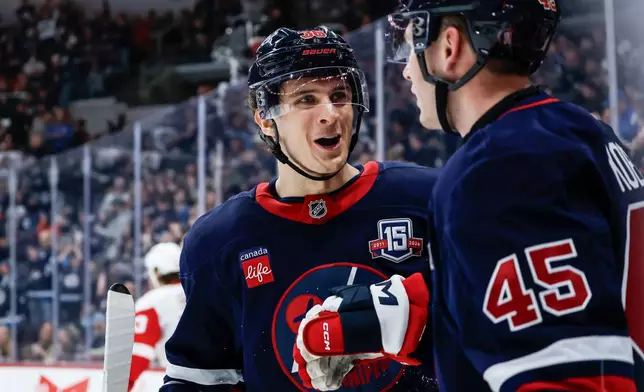 Winnipeg Jets' Morgan Barron (36) and Cole Koepke (45) celebrate Koepke's goal against the Detroit Red Wings during the second period of an NHL game in Winnipeg, Saturday, Jan. 24, 2026. (John Woods/The Canadian Press via AP)