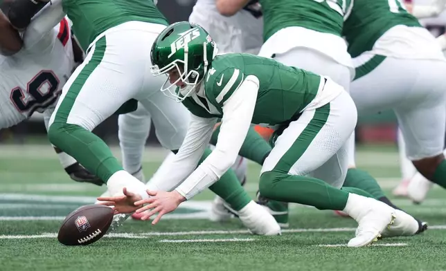 New York Jets quarterback Brady Cook (4) dives for a fumble against the New England Patriots during the first half of an NFL football game, Sunday, Dec. 28, 2025, in East Rutherford, N.J. (AP Photo/Frank Franklin)