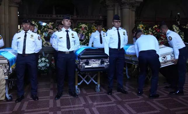 The wake for police officers killed while retaking control of three prisons is held at the Interior Ministry in Guatemala City, Monday, Jan. 19, 2026. (AP Photo/Moises Castillo)