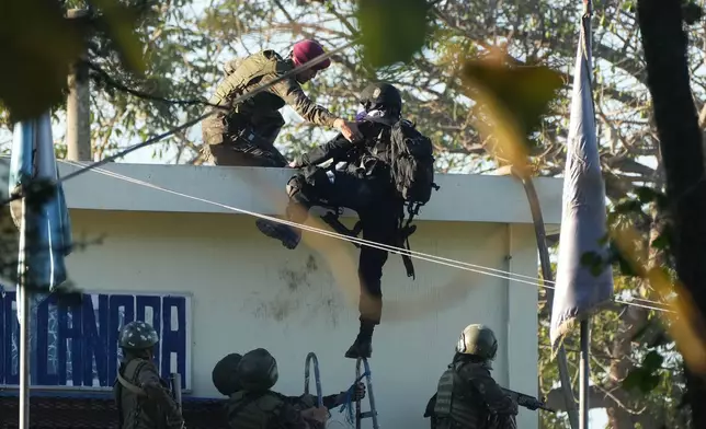 Security forces enter the Renovation maximum-security prison to free guards taken hostage and retake control of the facility, which houses gang leaders, in Escuintla, Guatemala, Sunday, Jan. 18, 2026. (AP Photo/Moises Castillo)
