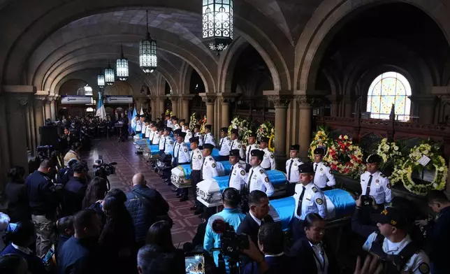 The wake for police officers killed while retaking control of three prisons is held at the Interior Ministry in Guatemala City, Monday, Jan. 19, 2026. (AP Photo/Moises Castillo)