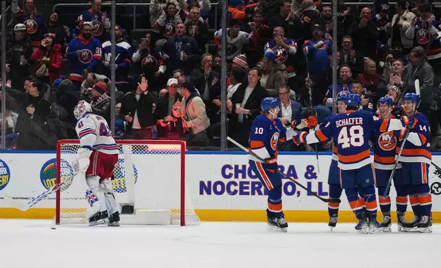 New York Rangers goaltender Spencer Martin (41) skates away as the New York Islanders celebrate a goal by Ondrej Palat during the first period of an NHL hockey game Wednesday, Jan. 28, 2026, in Elmont, N.Y. (AP Photo/Frank Franklin II)