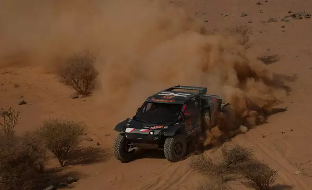 Driver Nasser Al-Attiyah and co-driver Fabian Lurquin compete during the eleventh stage of the Dakar Rally between Bisha and Al Henakiyah, Saudi Arabia, Thursday, Jan.15, 2026. (AP Photo/Thibault Camus)
