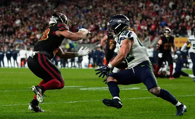 Seattle Seahawks linebacker Drake Thomas, right, intercepts a pass intended for San Francisco 49ers running back Christian McCaffrey, left, during the second half of an NFL football game in Santa Clara, Calif., Saturday, Jan. 3, 2026. (AP Photo/Godofredo A. Vásquez)