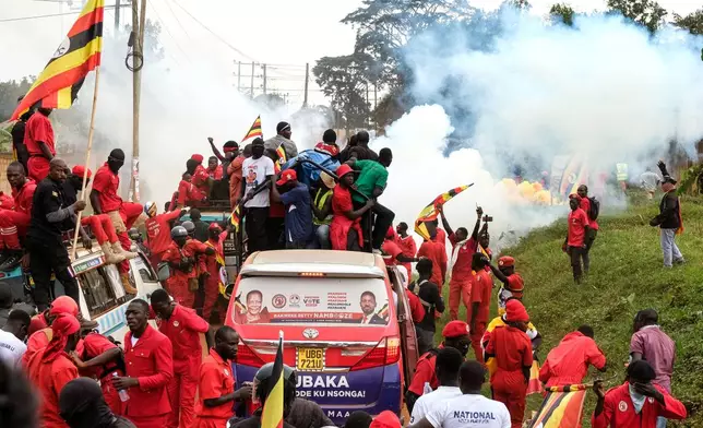 Supporters of Ugandan opposition presidential candidate Robert Kyagulanyi Ssentamu who is known as Bobi Wine are tear-gassed by police during a campaign rally ahead of elections, in Mukono, Uganda, Friday, Jan. 9, 2026. (AP Photo/Hajarah Nalwadda)