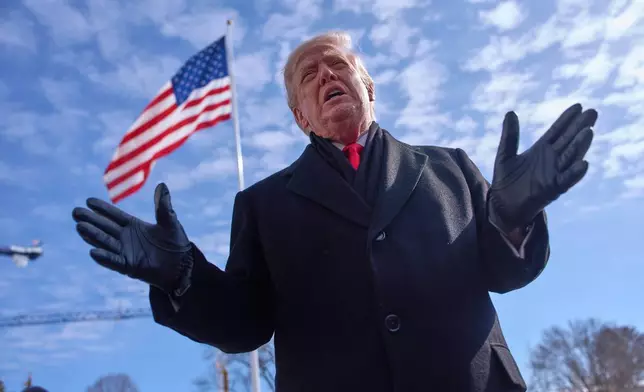 President Donald Trump speaks with reporters before boarding Marine One on South Lawn of the White House, Tuesday, Jan. 27, 2026, in Washington. (AP Photo/Evan Vucci)