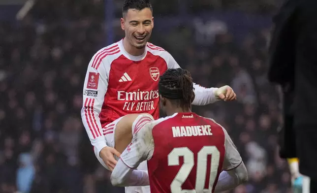 Arsenal's Gabriel Martinelli and Noni Madueke celebrate after a goal during the FA Cup third round soccer match between Portsmouth and Arsenal in Portsmouth, England, Sunday, Jan. 11, 2026. (AP Photo/Kin Cheung)