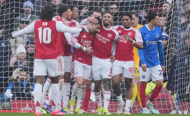 Arsenal players celebrate after a goal during the FA Cup third round soccer match between Portsmouth and Arsenal in Portsmouth, England, Sunday, Jan. 11, 2026. (AP Photo/Kin Cheung)