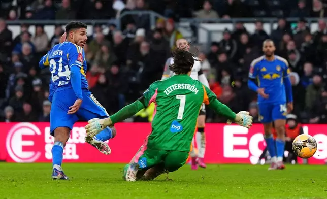 Leeds United's James Justin scores their side's third goal of the game during the Emirates FA Cup third round match between Derby County and Leeds United, in Derby, England, Sunday Jan. 11, 2026. (David Davies/PA via AP)