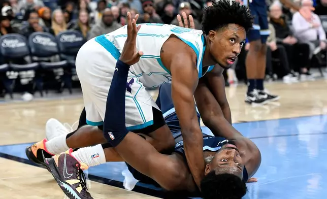 Charlotte Hornets guard Collin Sexton, top, and Memphis Grizzlies forward Jaren Jackson Jr. look to a referee in the first half of an NBA basketball game, Wednesday, Jan. 28, 2026, in Memphis, Tenn. (AP Photo/Brandon Dill)