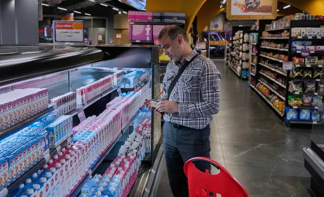 FILE - A customer shops at a supermarket at a shopping mall in northern Tehran, on Sept. 28, 2025. (AP Photo/Vahid Salemi, File)