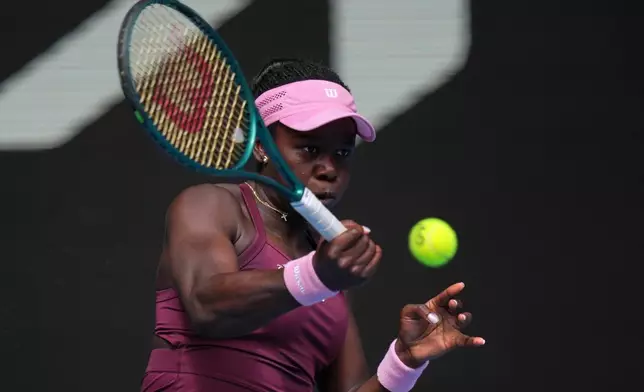 Victoria Mboko of Canada plays a forehand return to Aryna Sabalenka of Belarus during their fourth round match at the Australian Open tennis championship in Melbourne, Australia, Sunday, Jan. 25, 2026. (AP Photo/Dita Alangkara)