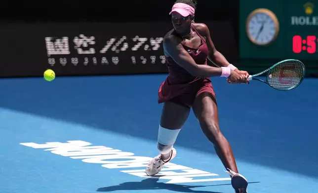 Victoria Mboko of Canada plays a backhand return to Aryna Sabalenka of Belarus during their fourth round match at the Australian Open tennis championship in Melbourne, Australia, Sunday, Jan. 25, 2026. (AP Photo/Dita Alangkara)